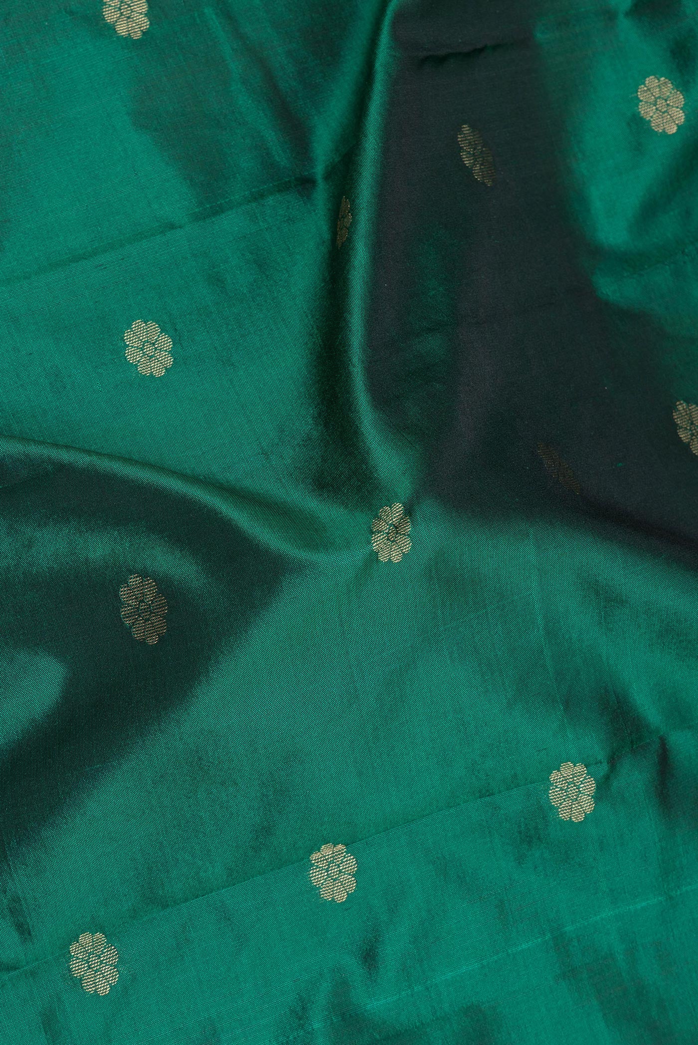 Close up of Bottle Green Blended Paithani Silk Saree with Zari Butta on the body and Zari Border.  displaying folds