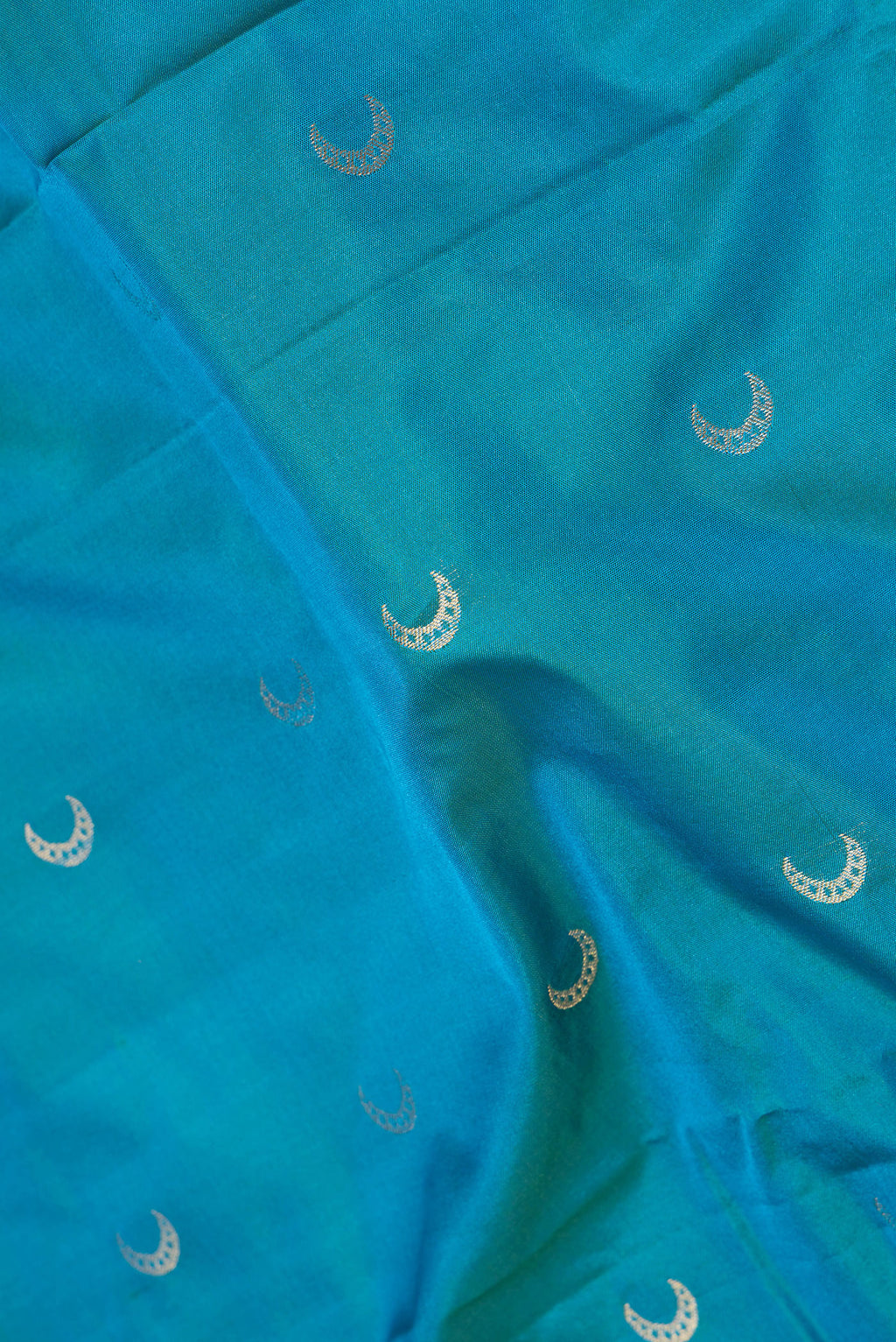 Close up of Blue Dual Tone Blended Paithani Silk Saree with Zari Butta on the body and Zari Border.  displaying folds