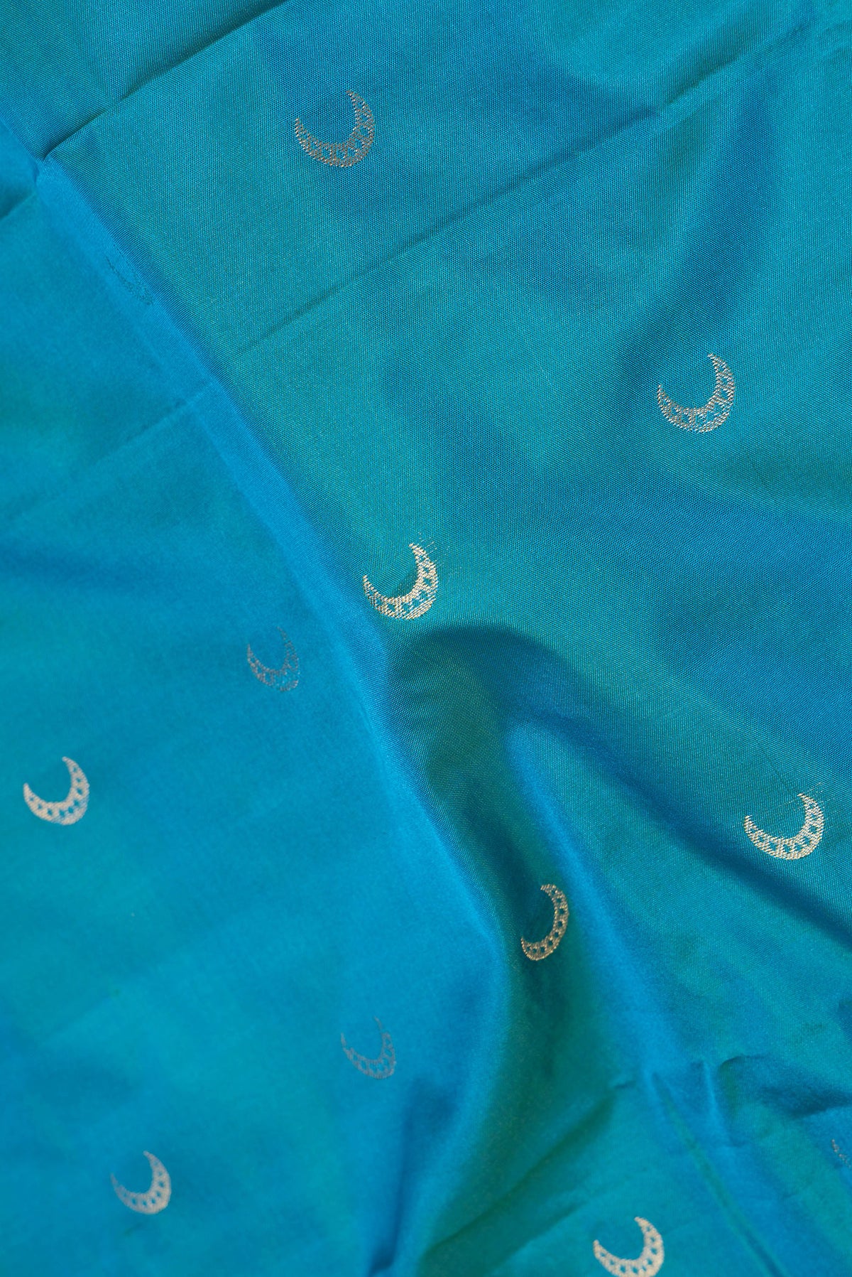 Close up of Blue Dual Tone Blended Paithani Silk Saree with Zari Butta on the body and Zari Border.  displaying folds