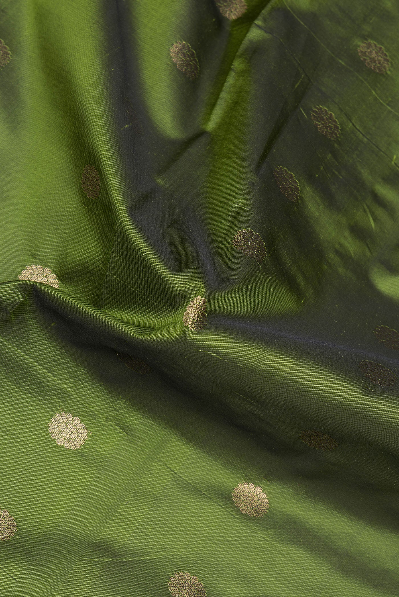Close up of Mehandi Green Blended Paithani Silk Saree with Zari Butta on the body and Zari Border.  displaying folds