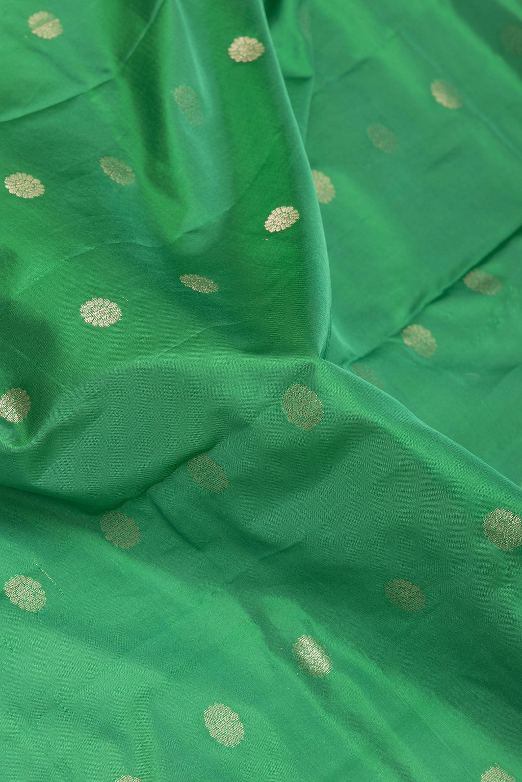 Close up of Green Paithani Silk Saree with Zari Butta on the body and Zari Border.  displaying folds