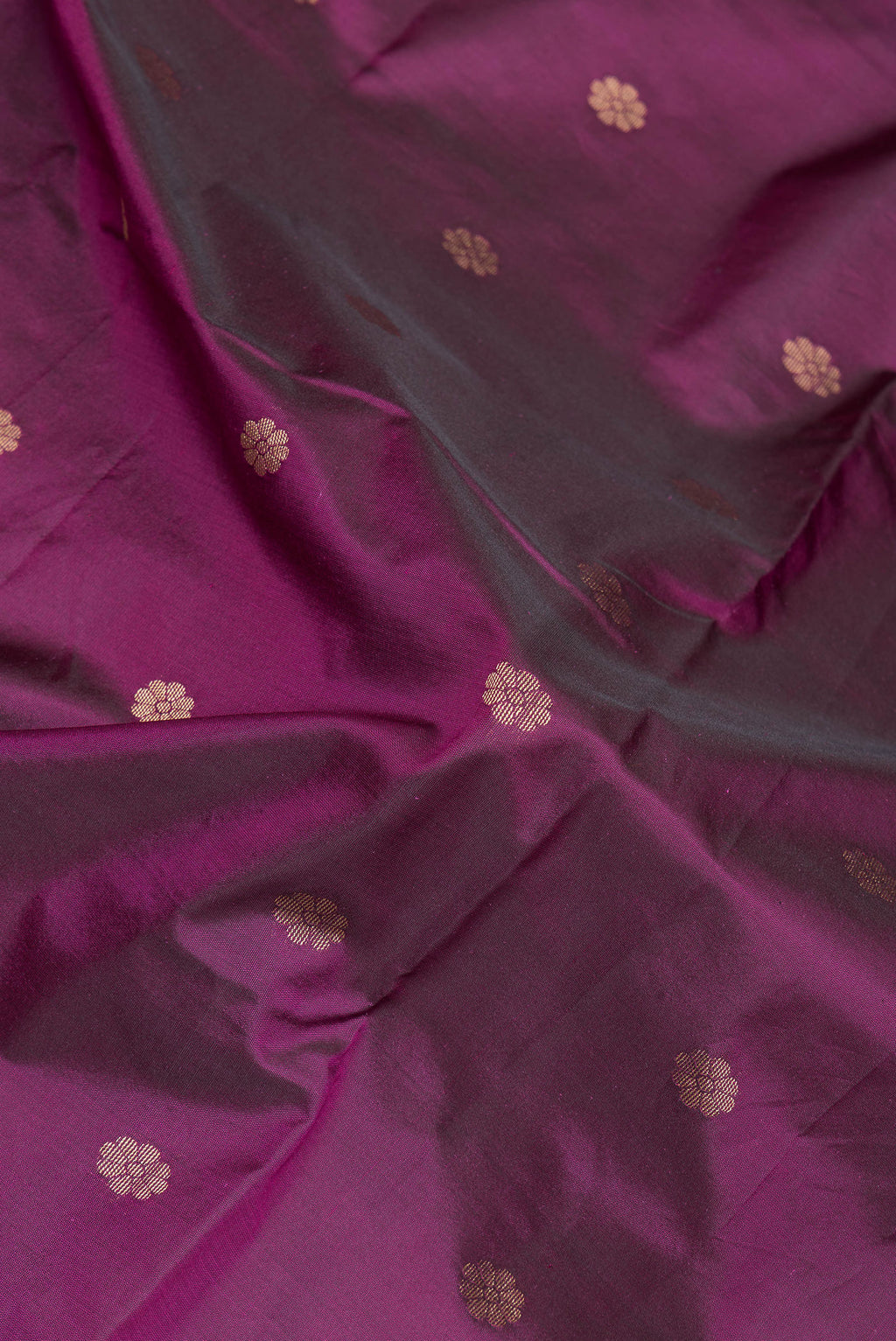 Close up of Magenta Paithani Silk Saree with Zari Butta on the body and Zari Border.  displaying folds