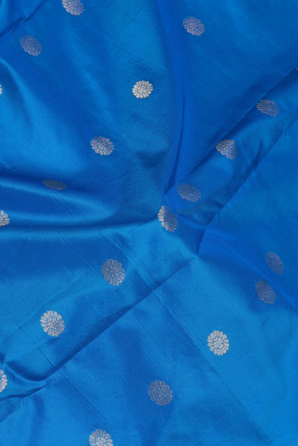 Close up of Royal Blue Paithani Silk Saree with Zari Butta on the body and Zari Border.  displaying folds