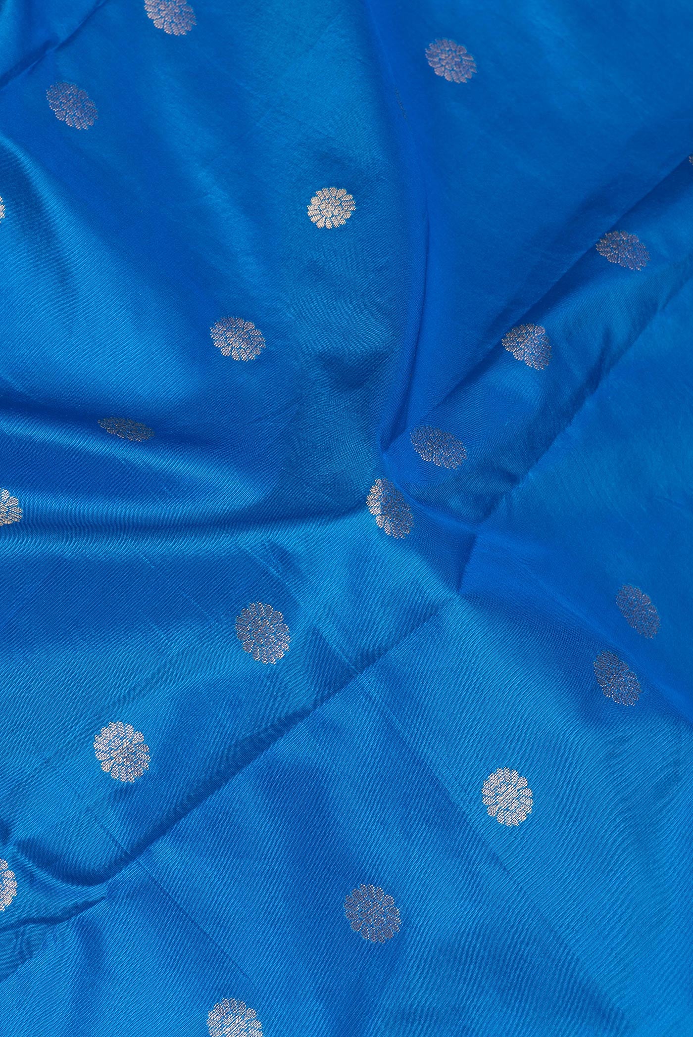 Close up of Royal Blue Paithani Silk Saree with Zari Butta on the body and Zari Border.  displaying folds