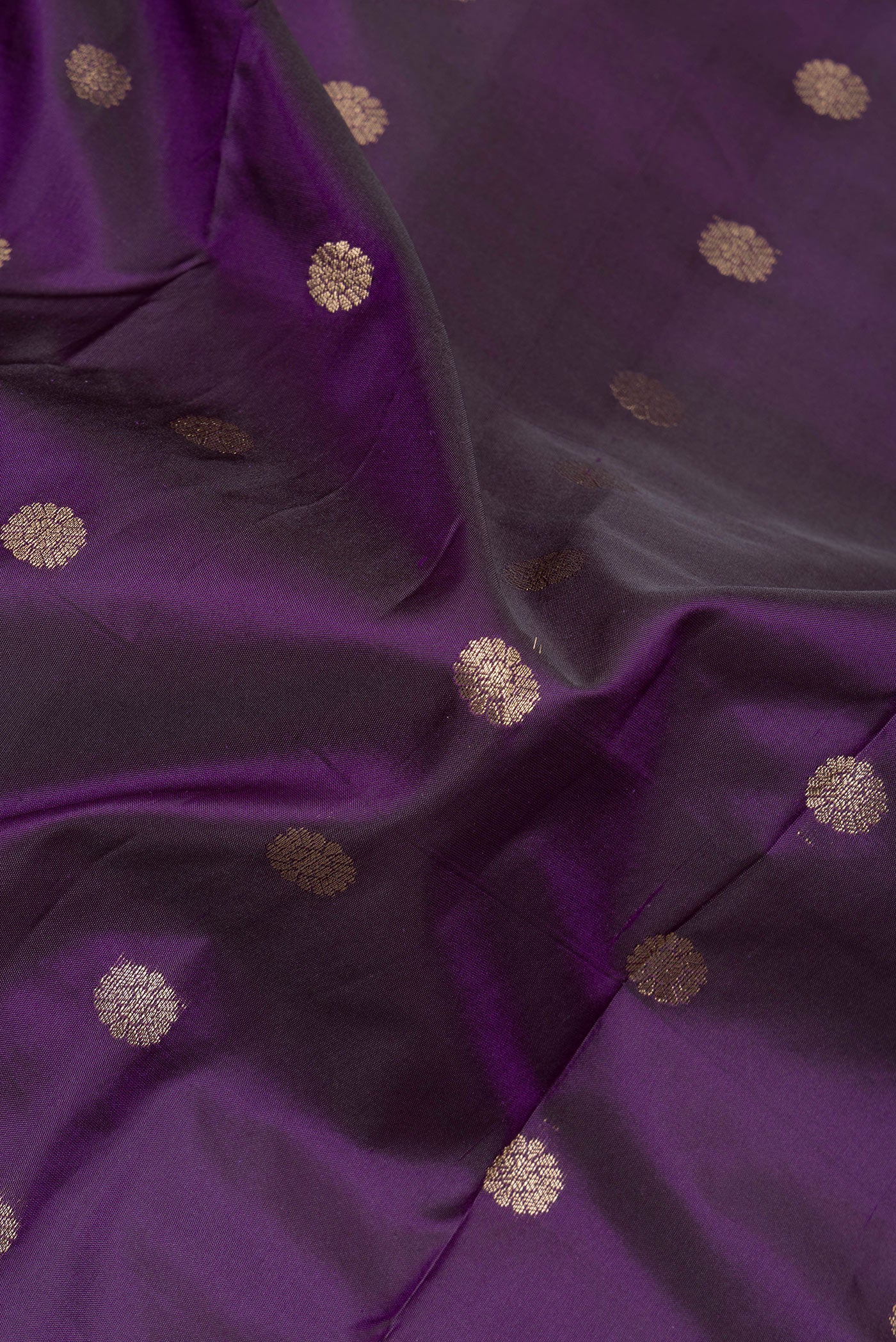 Close up of Violet Paithani Silk Saree with Zari Butta on the body and Zari Border.  displaying folds