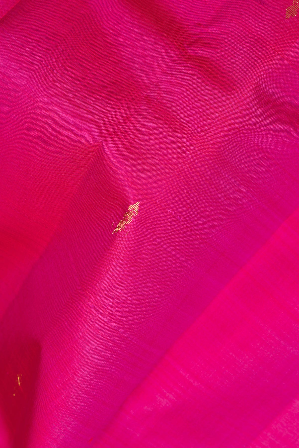 Close up of Pure Silk Pink Kanchipuram Saree with Zari Butta on the body and Fancy Border.  displaying folds