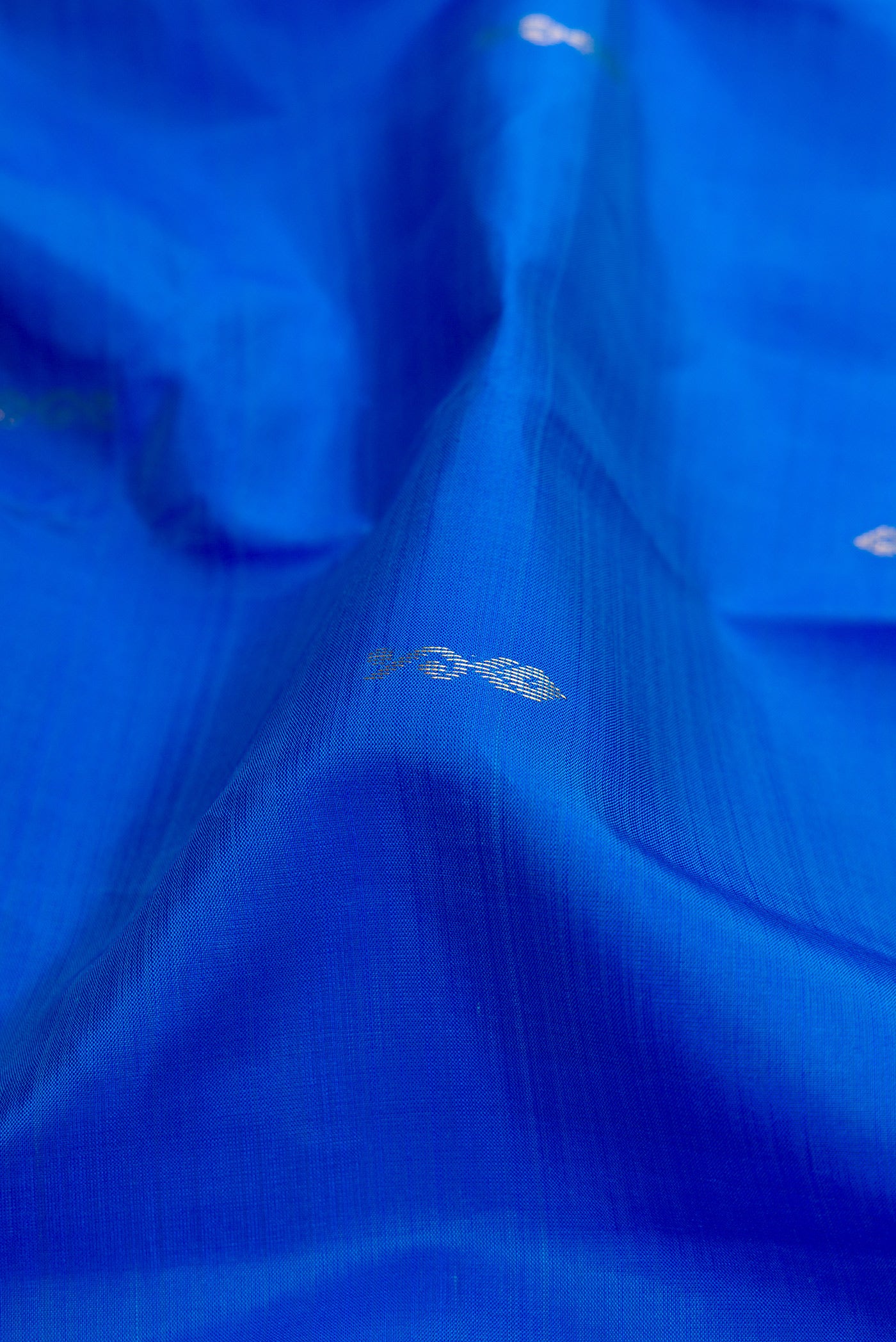 Close up of Blue Kanchipuram Silk Saree with Zari Butta on the body and Fancy Border.  displaying folds