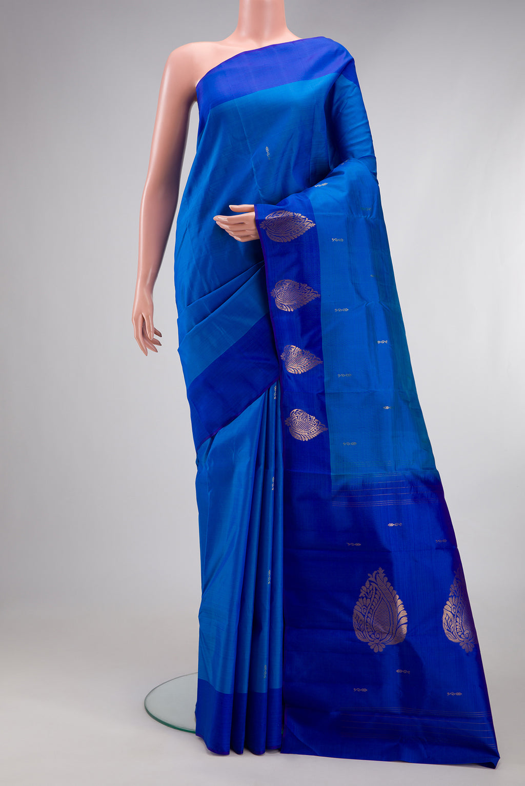 Blue Kanchipuram Silk Saree with Zari Butta on the body and Fancy Border.  displayed on a mannequin