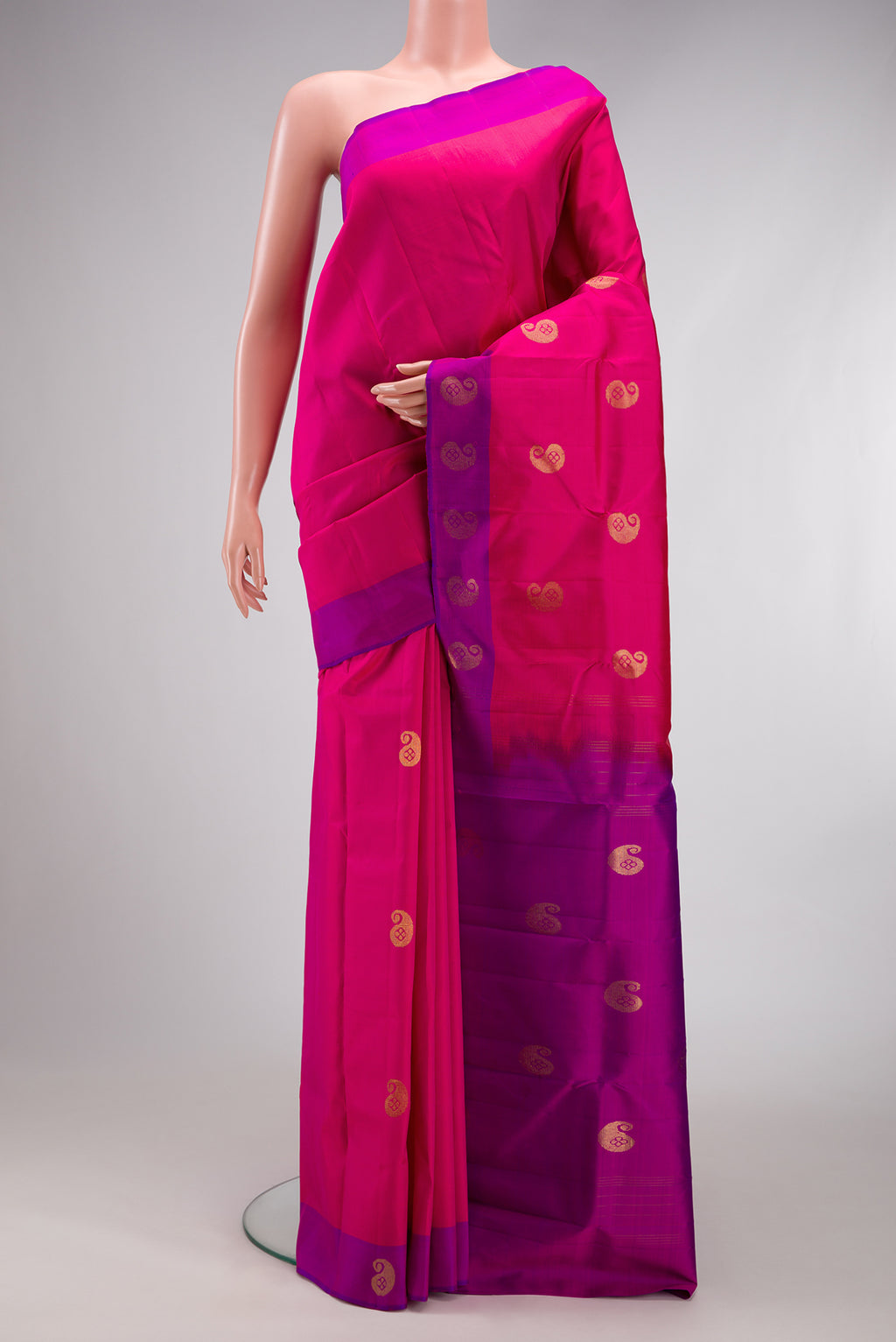 Dark Pink Kanchipuram Silk Saree with Zari Butta on the body and Fancy Border.  displayed on a mannequin