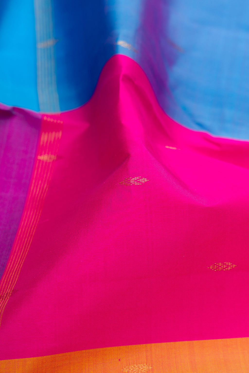 Close up of Multi Color Kanchipuram Silk Saree with Zari Butta on the body and Thin Zari Line.  displaying folds