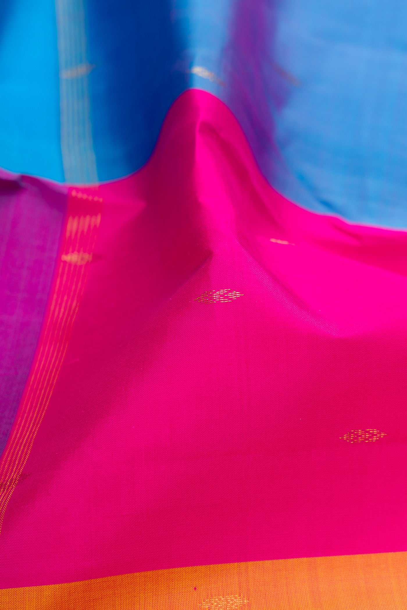 Close up of Multi Color Kanchipuram Silk Saree with Zari Butta on the body and Thin Zari Line.  displaying folds