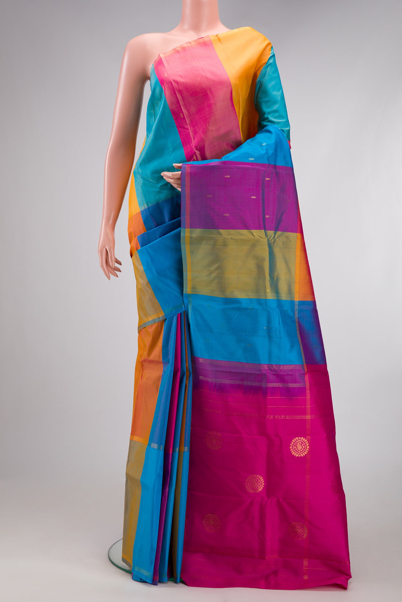 Multi Color Kanchipuram Silk Saree with Zari Butta on the body and Thin Zari Line.  displayed on a mannequin