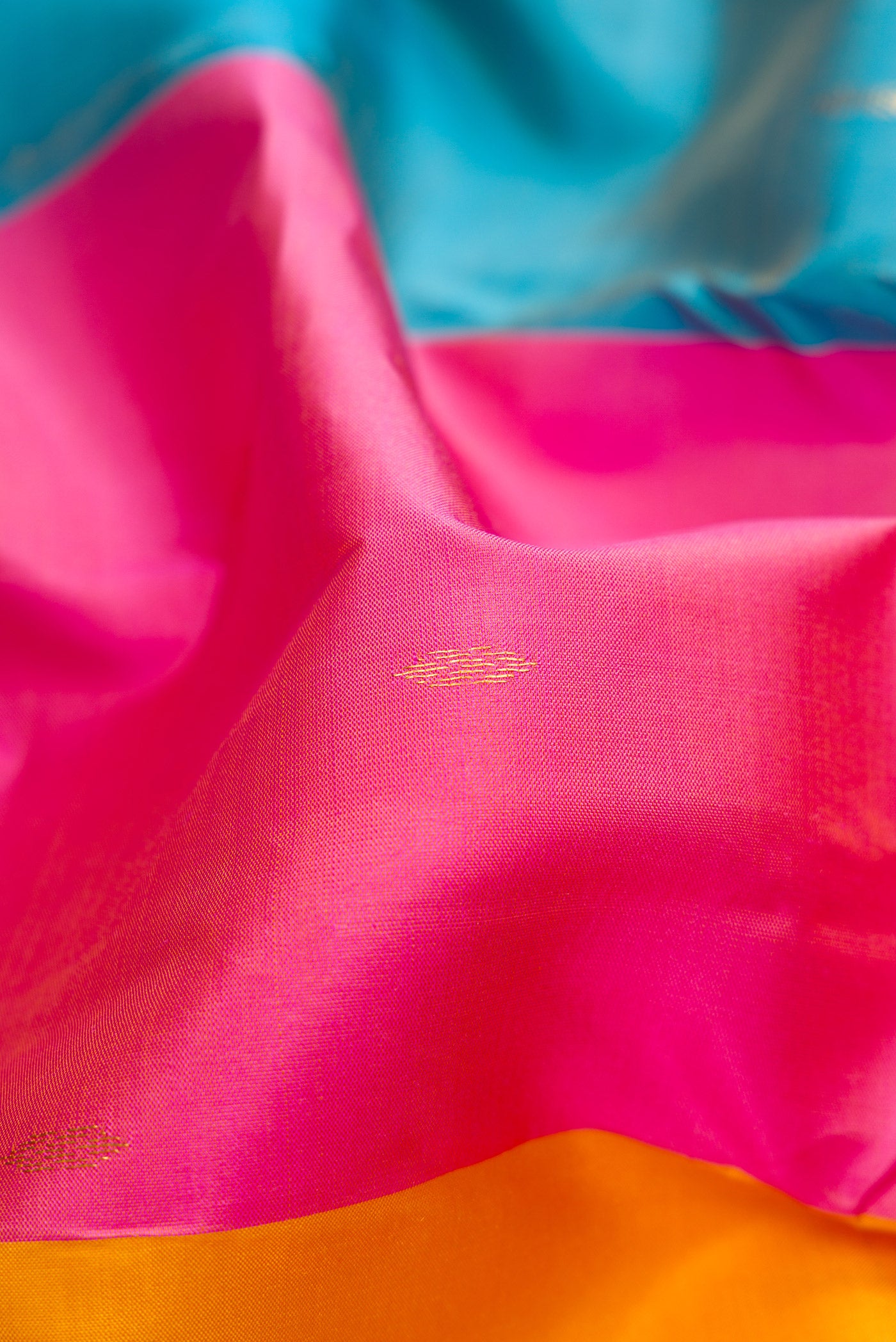 Close up of Multi Color Kanchipuram Silk Saree with Zari Butta on the body and Zari Border.  displaying folds