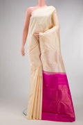 Cream Kanchipuram Silk Saree with Zari Butta on the body and Without Border.  displayed on a mannequin