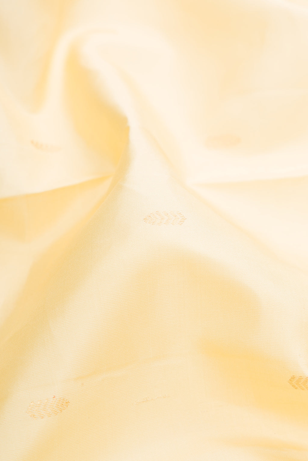 Close up of Sandal Kanchipuram Silk Saree with Zari Butta on the body and Without Border.  displaying folds