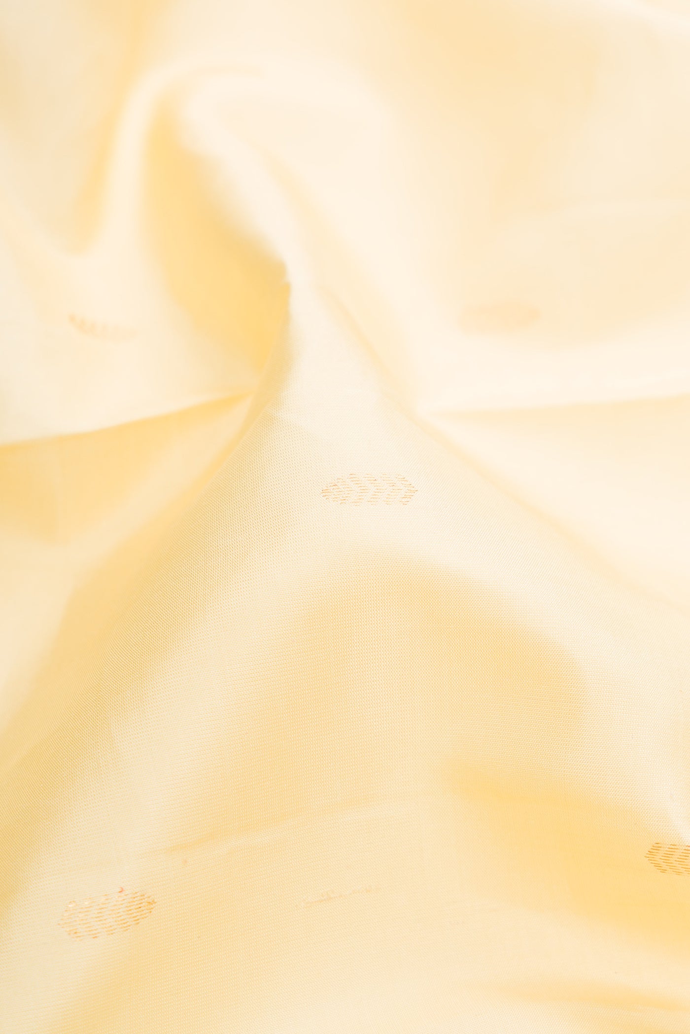 Close up of Sandal Kanchipuram Silk Saree with Zari Butta on the body and Without Border.  displaying folds