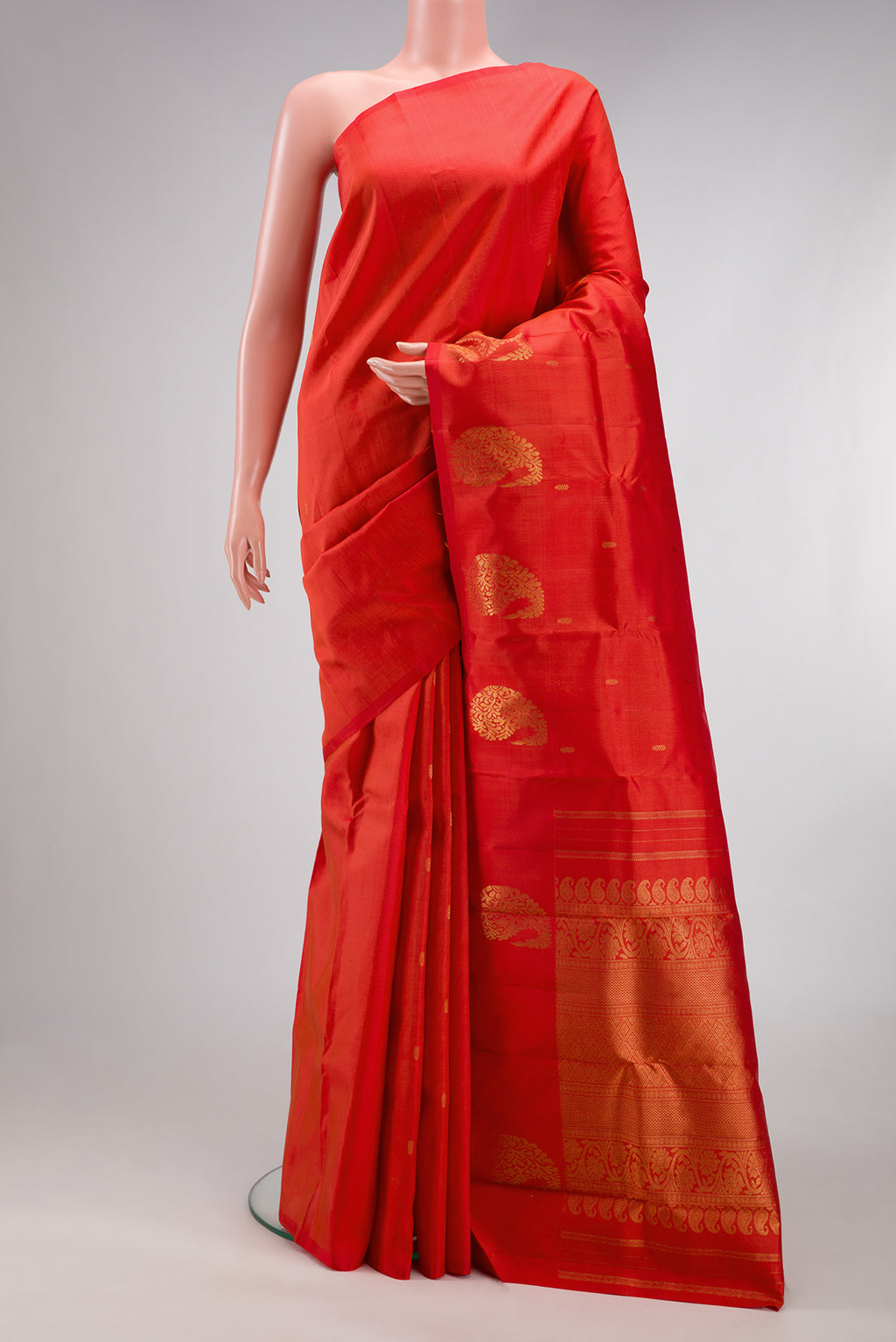 Red Kanchipuram Silk Saree with Zari Butta on the body and Without Border.  displayed on a mannequin