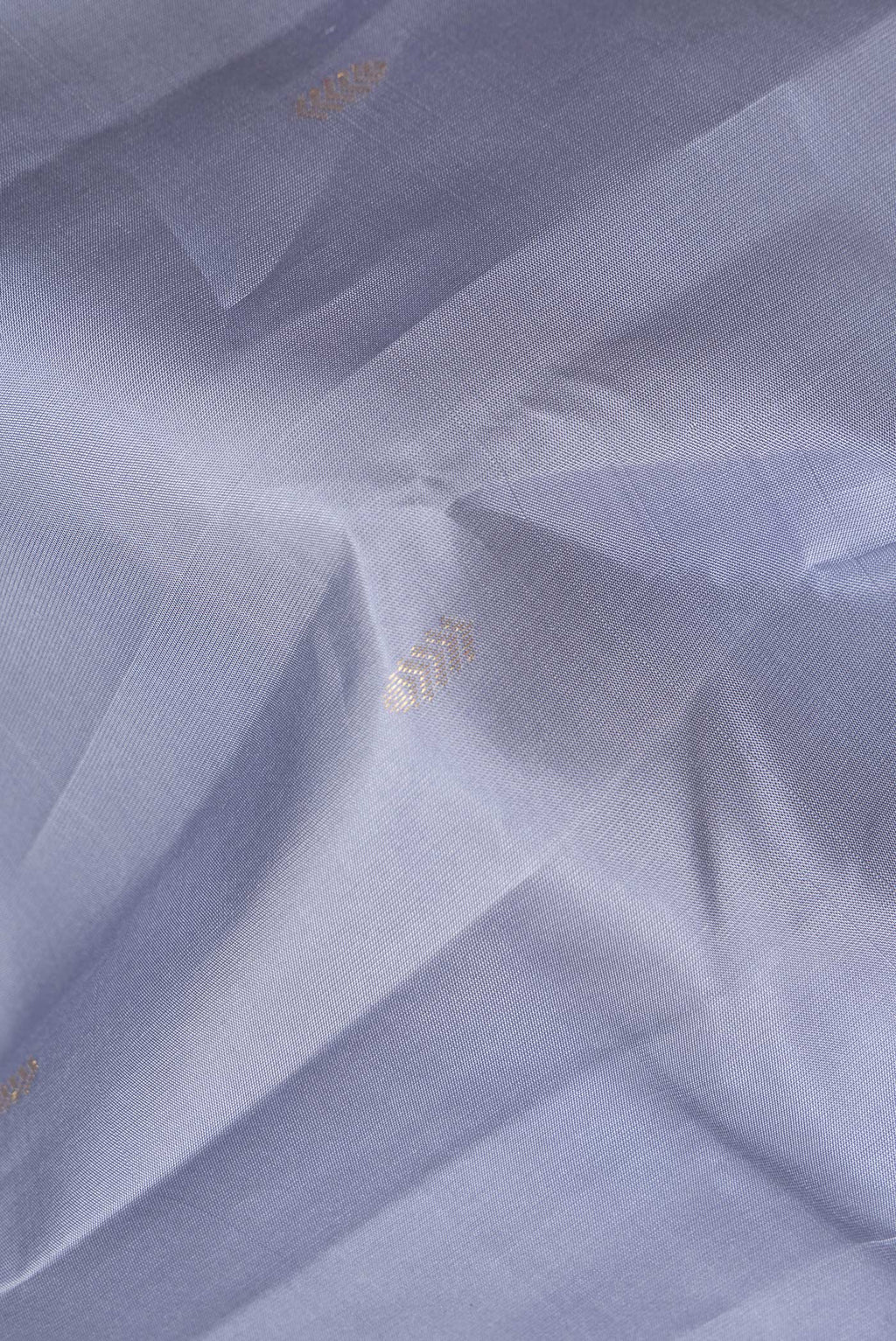 Close up of Pure Silk Grey Kanchipuram Saree with Zari Butta on the body and Without Border.  displaying folds