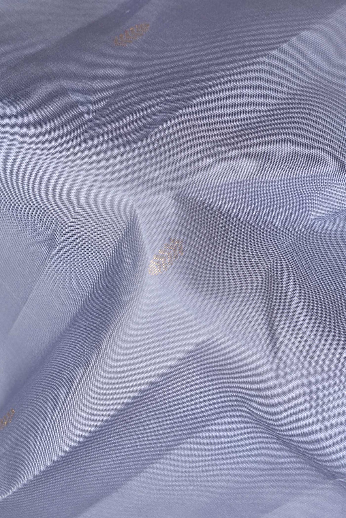 Close up of Pure Silk Grey Kanchipuram Saree with Zari Butta on the body and Without Border.  displaying folds