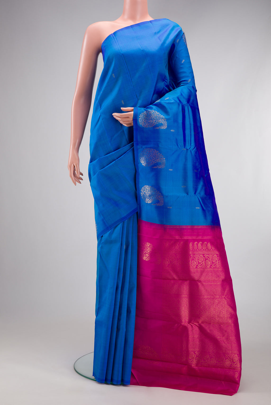 Blue Kanchipuram Silk Saree with Zari Butta on the body and Without Border.  displayed on a mannequin
