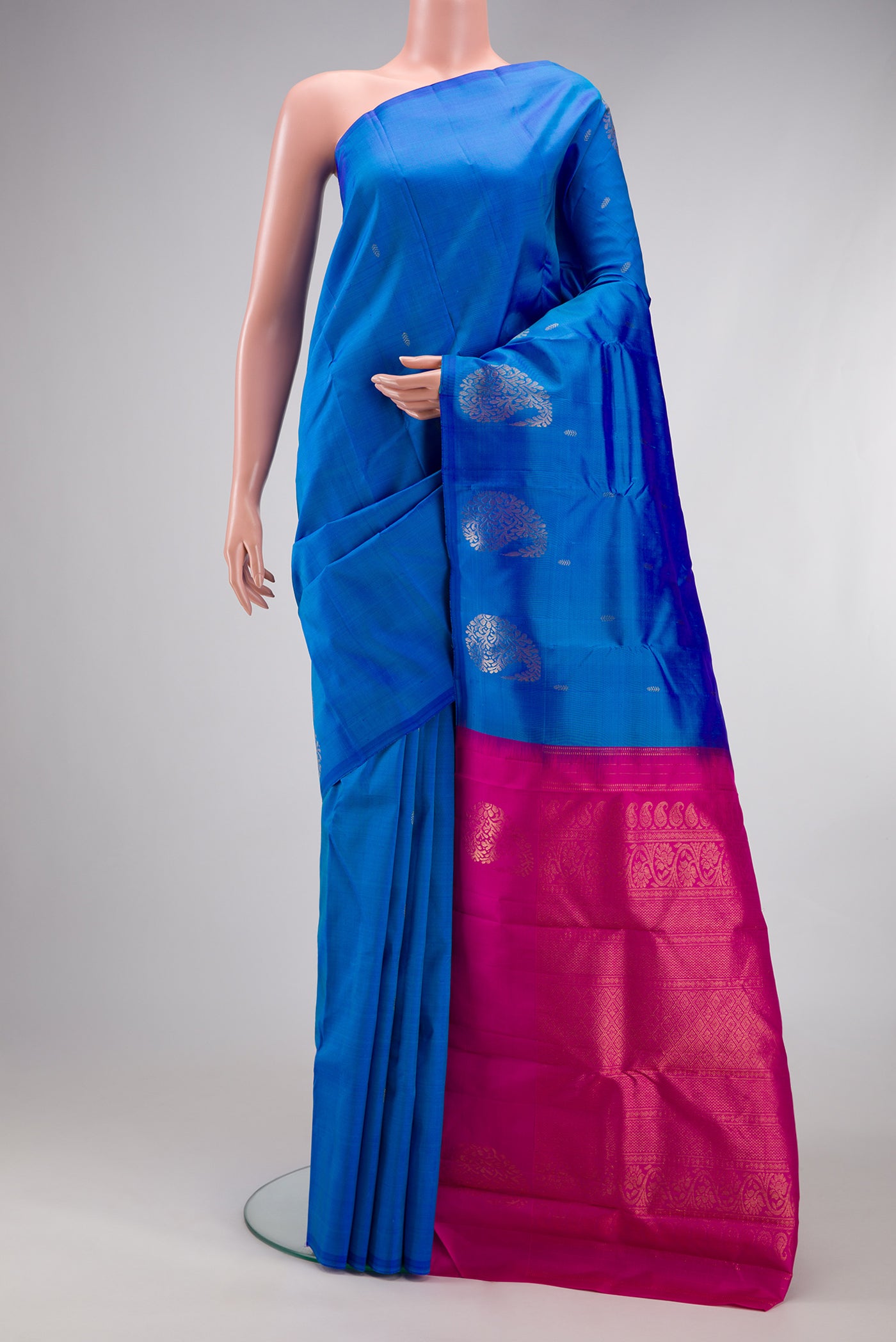 Blue Kanchipuram Silk Saree with Zari Butta on the body and Without Border.  displayed on a mannequin
