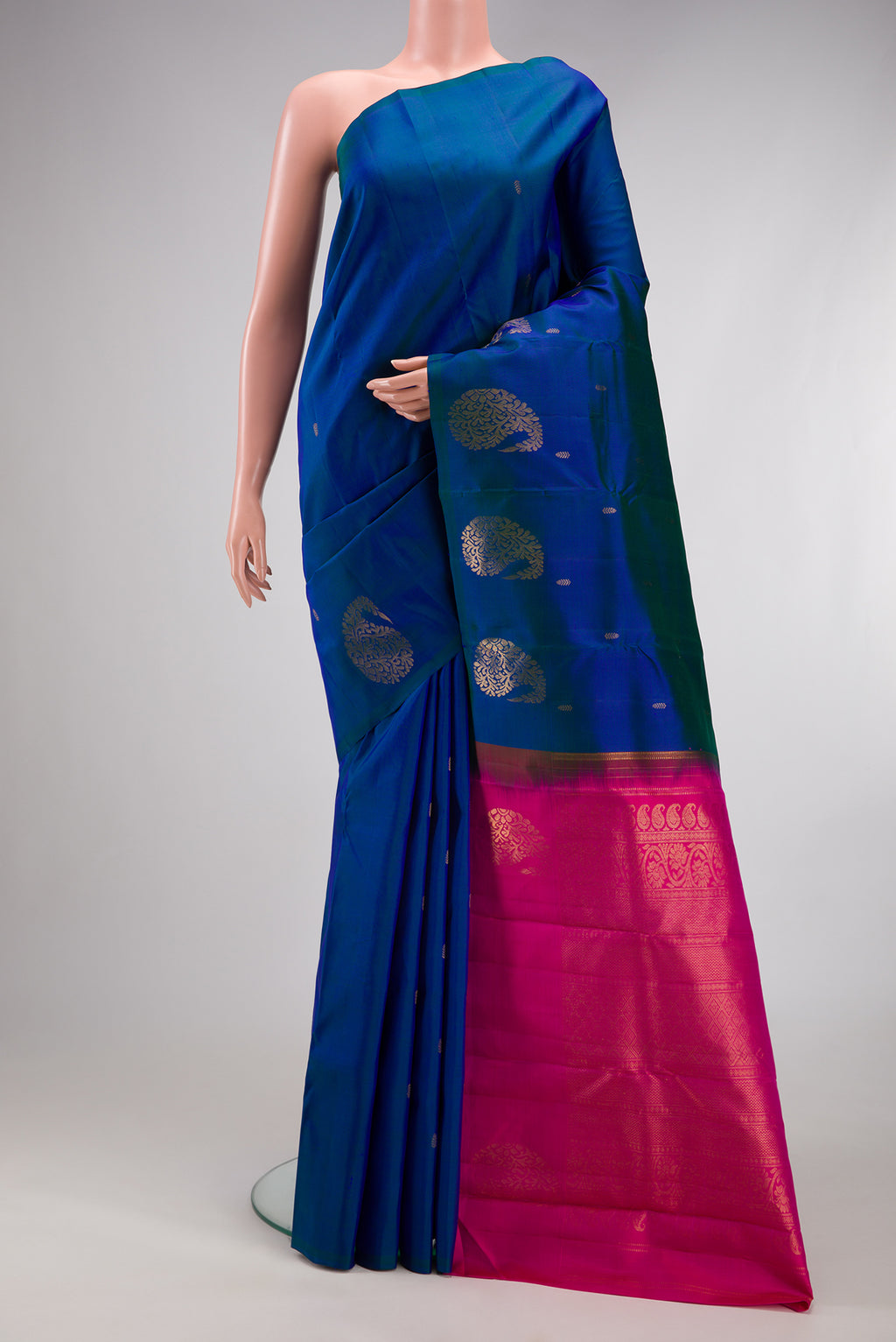Peacock Blue Kanchipuram Silk Saree with Zari Butta on the body and Fancy Border.  displayed on a mannequin