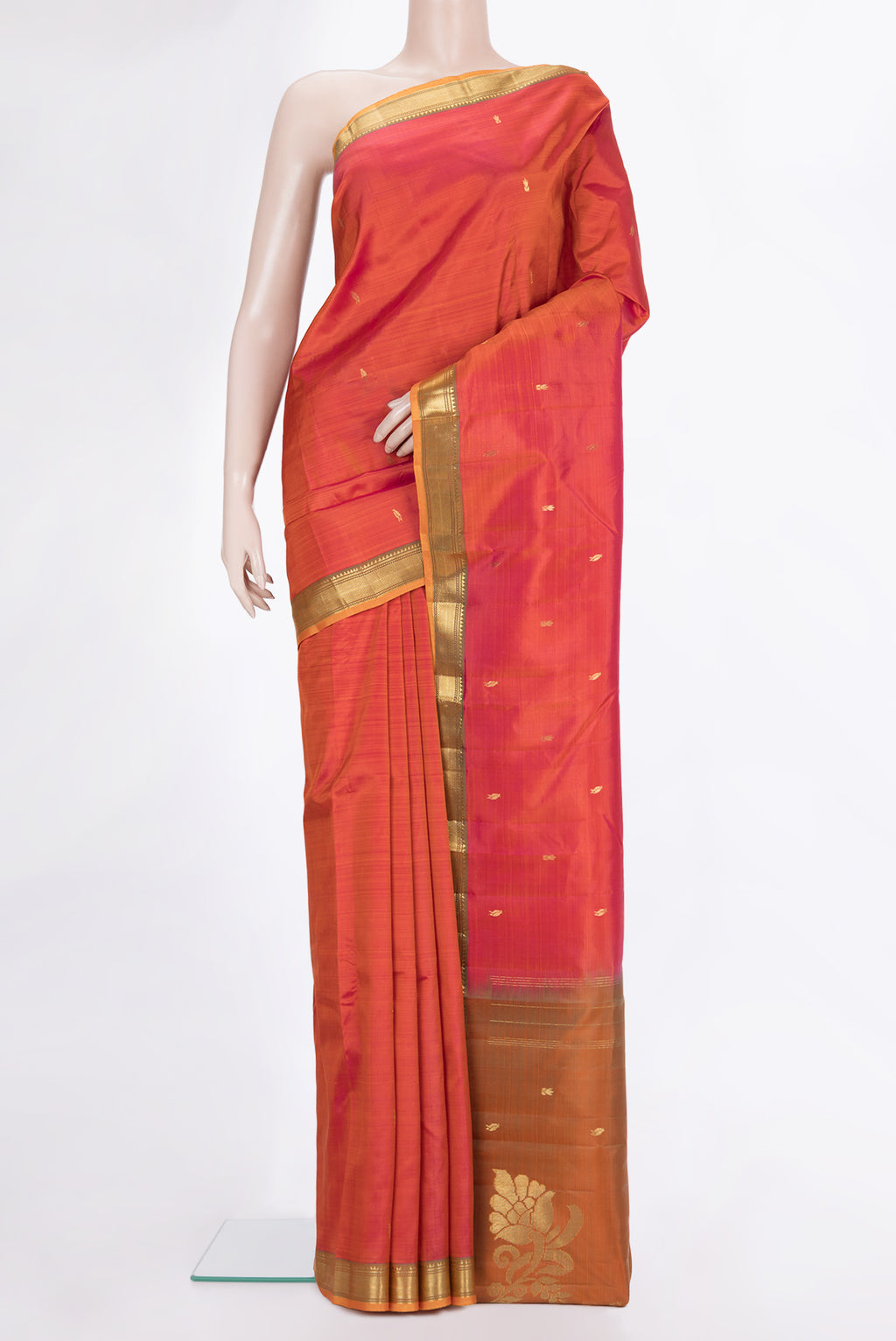 Pure Silk Brick Orange Kanjivaram Saree with Zari Butta on the body and Zari Border.  displayed on a mannequin