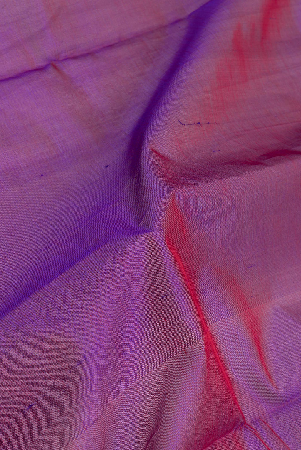 Close up of Purple Silk Cotton Saree with Plain Body and Zari Border.  displaying folds