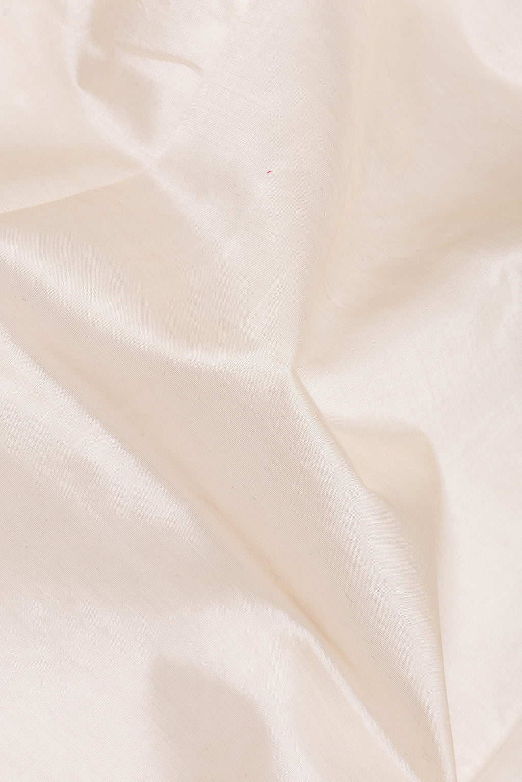 Close up of White Silk Cotton Saree with Plain Body and Zari Border.  displaying folds