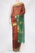 Brown Silk Cotton Saree with Zari Butta on the body and Zari Border.  displayed on a mannequin