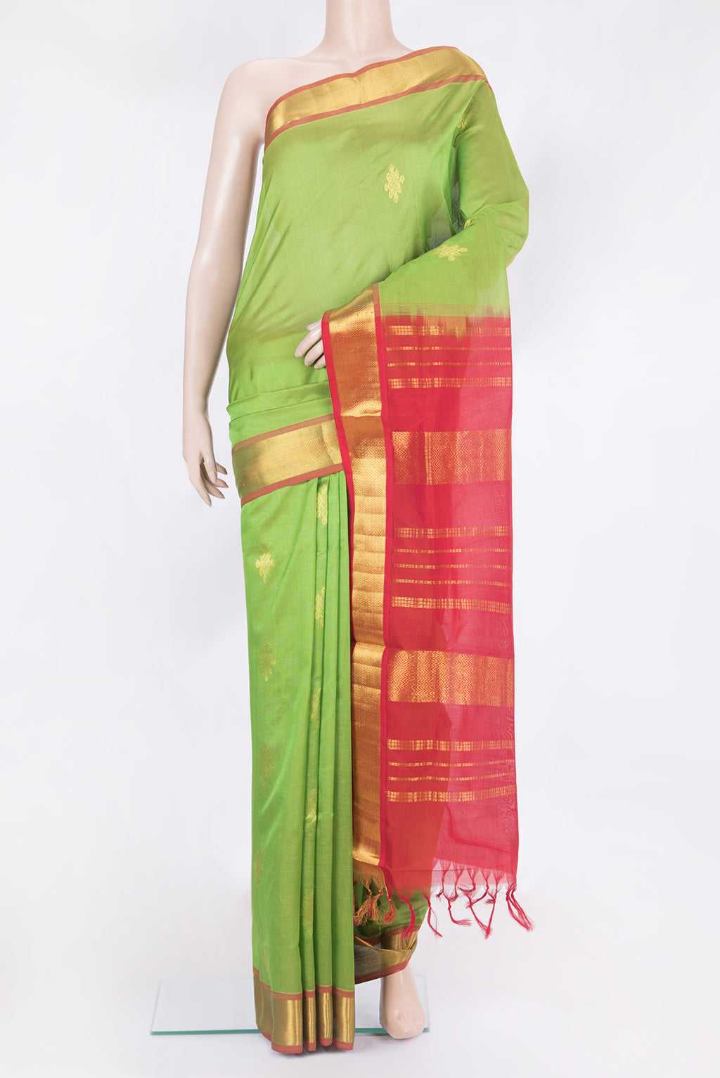 Light Green Silk Cotton Saree with Zari Butta on the body and Zari Border.  displayed on a mannequin