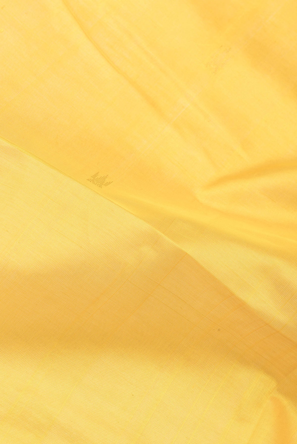 Close up of Yellow Silk Cotton Saree with Zari Butta on the body and Zari Border.  displaying folds