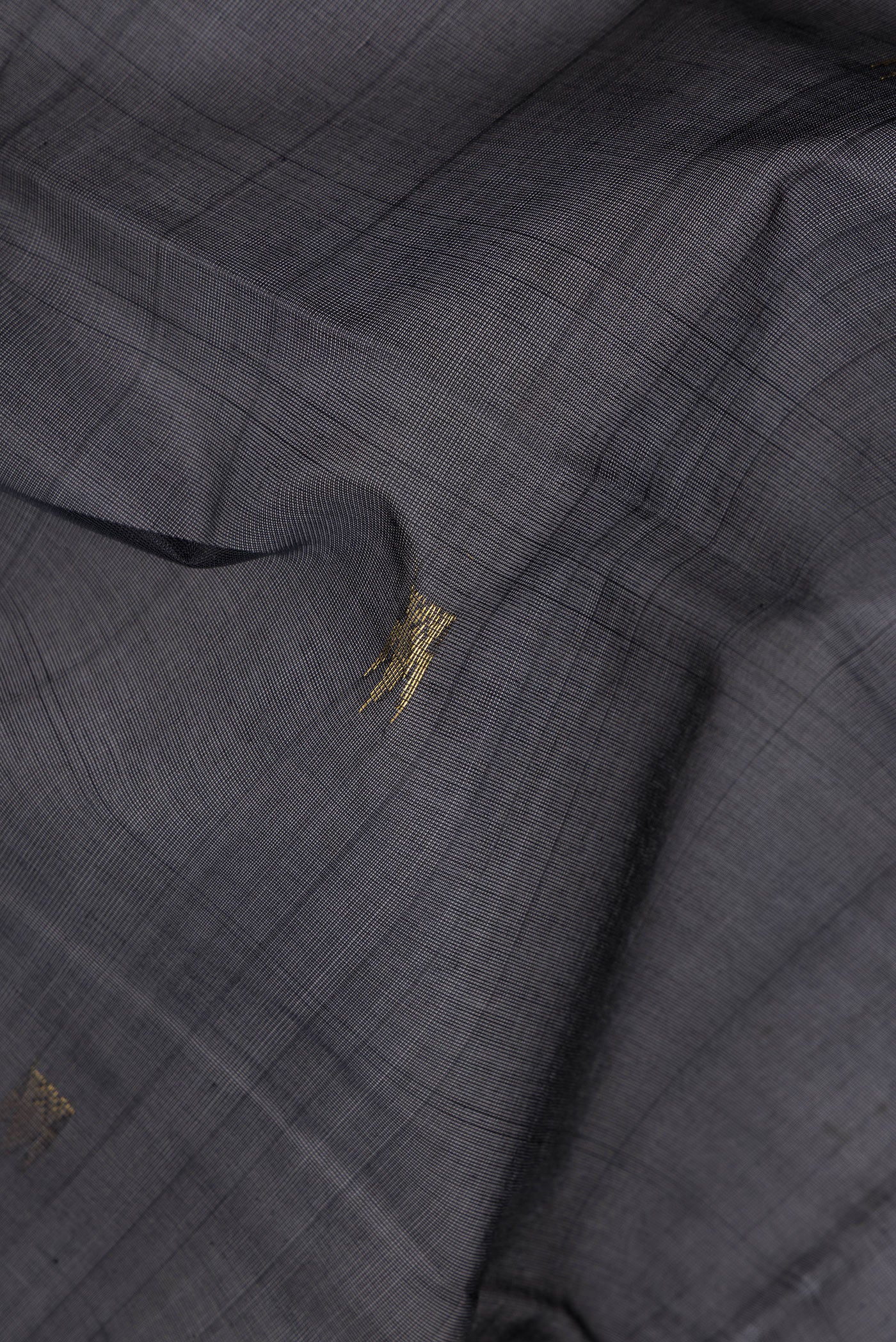 Close up of Black Silk Cotton Saree with Zari Butta on the body and Zari Border.  displaying folds