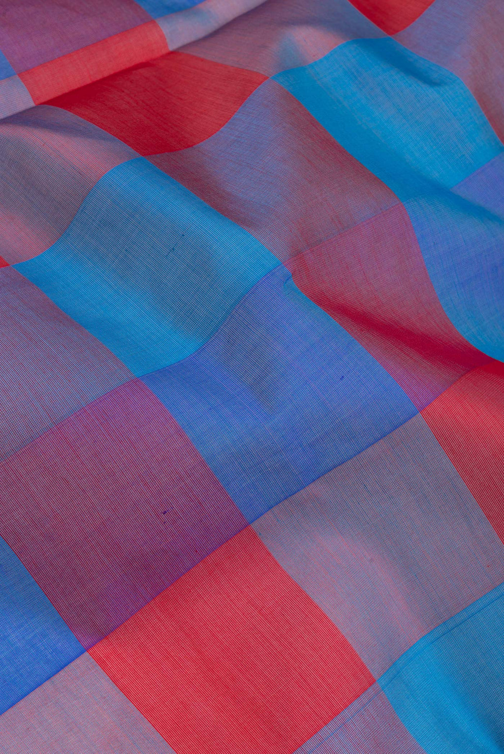 Close up of Multi Color Silk Cotton Saree with Checked design on the body and Zari And Thread Border.  displaying folds