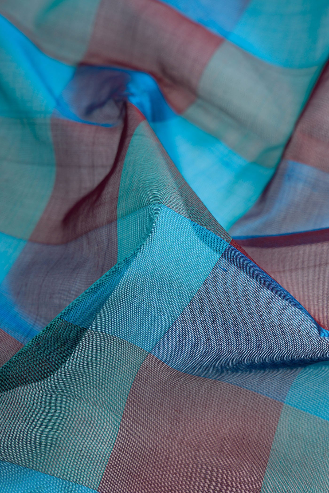 Close up of Multi Color Silk Cotton Saree with Checked design on the body and Zari And Thread Border.  displaying folds