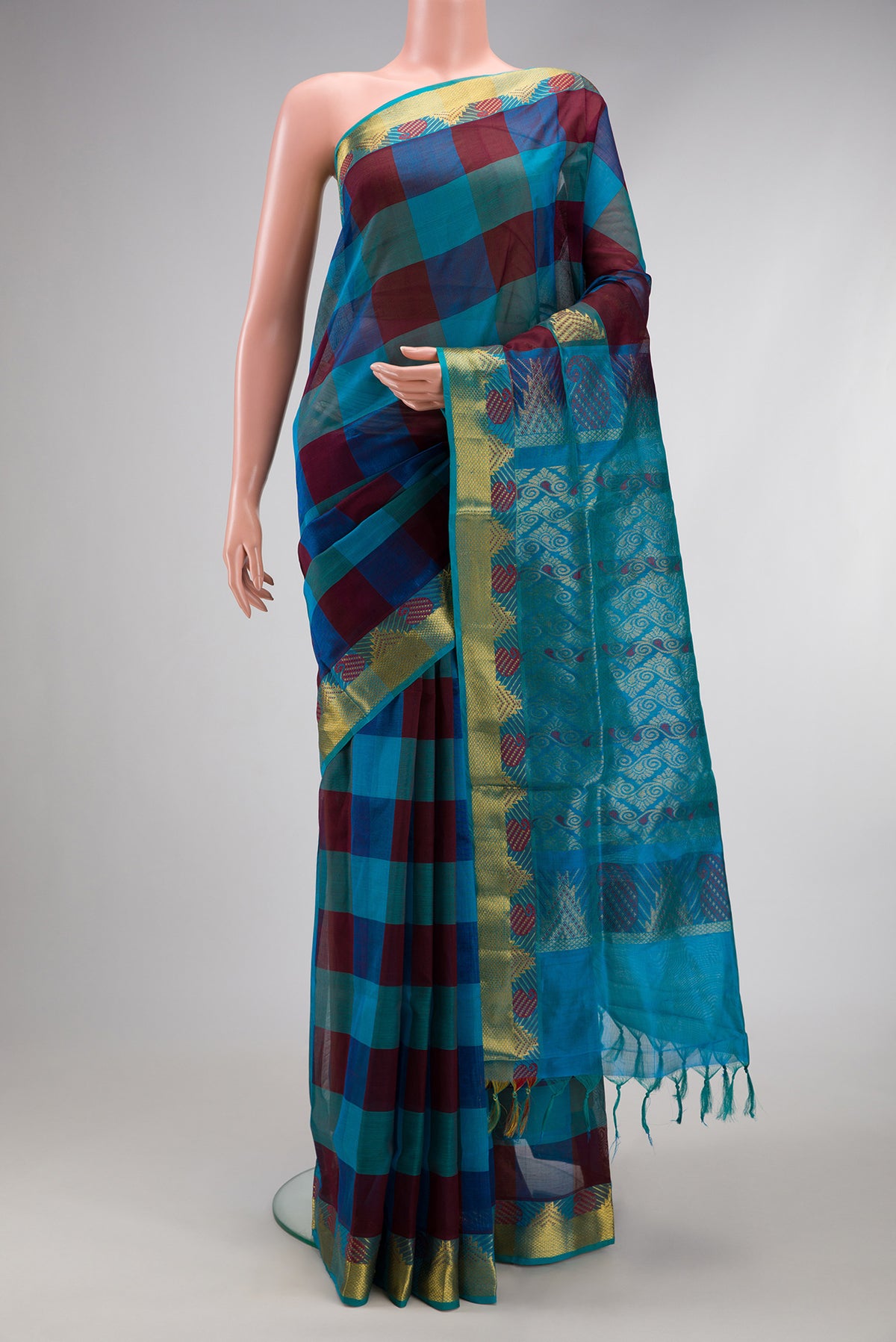 Multi Color Silk Cotton Saree with Checked design on the body and Zari And Thread Border.  displayed on a mannequin