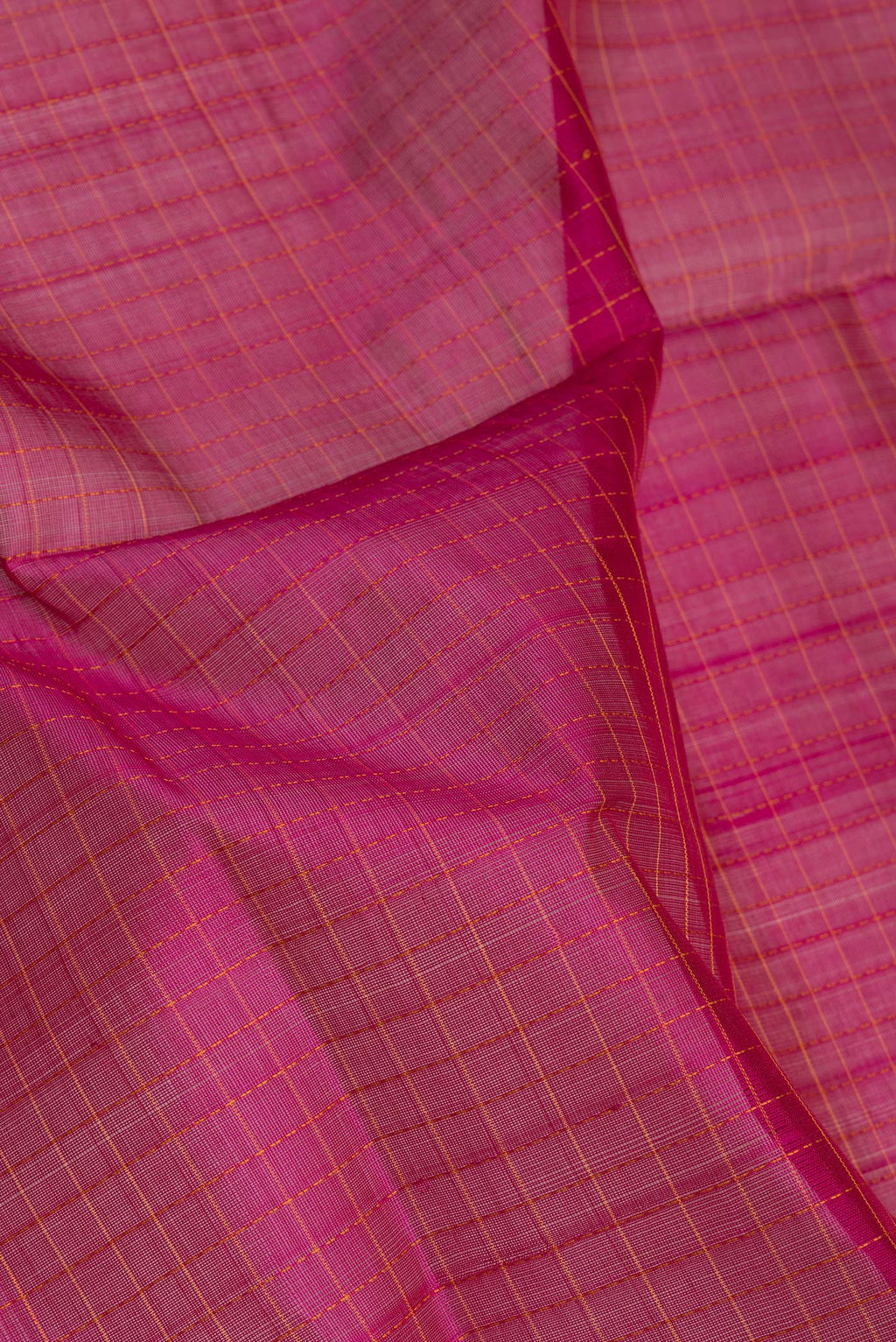 Close up of Magenta Silk Cotton Saree with Checked design on the body and Zari Border.  displaying folds