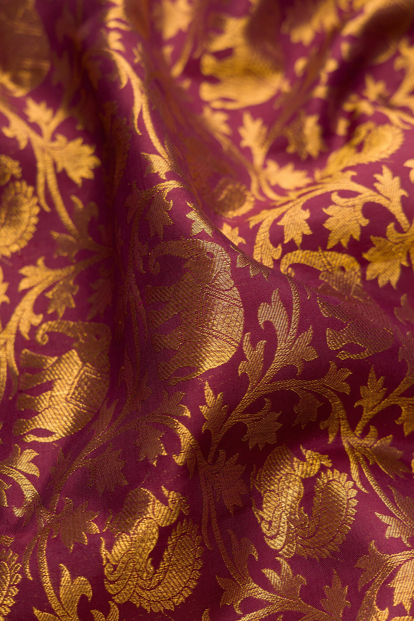 Close up of Maroon Kanchipuram Silk Saree with Zari Brocade on the body and Zari Border.  displaying folds