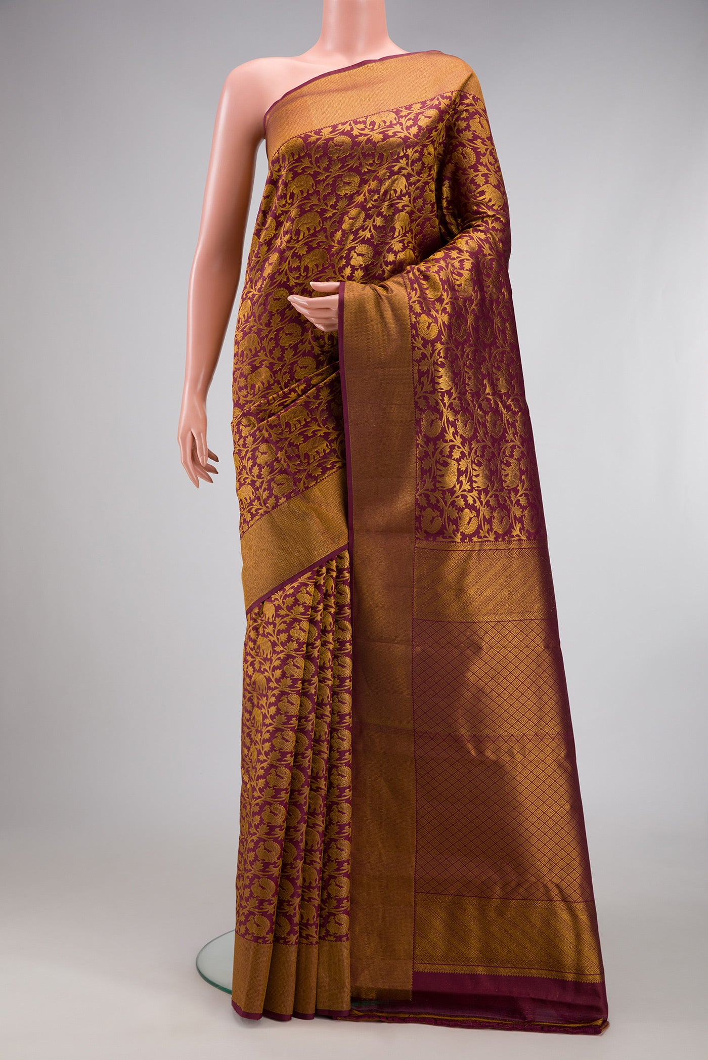 Maroon Kanchipuram Silk Saree with Zari Brocade on the body and Zari Border.  displayed on a mannequin