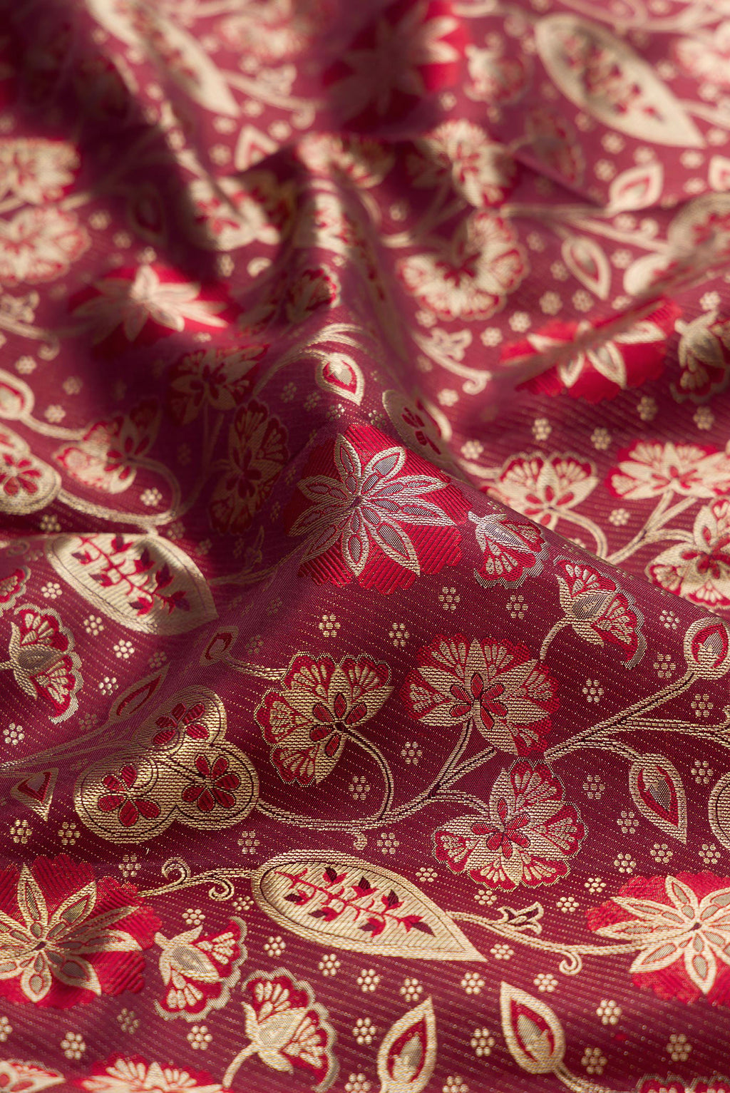 Close up of Maroon Kanchipuram Silk Saree with Zari Brocade on the body and Fancy Border.  displaying folds