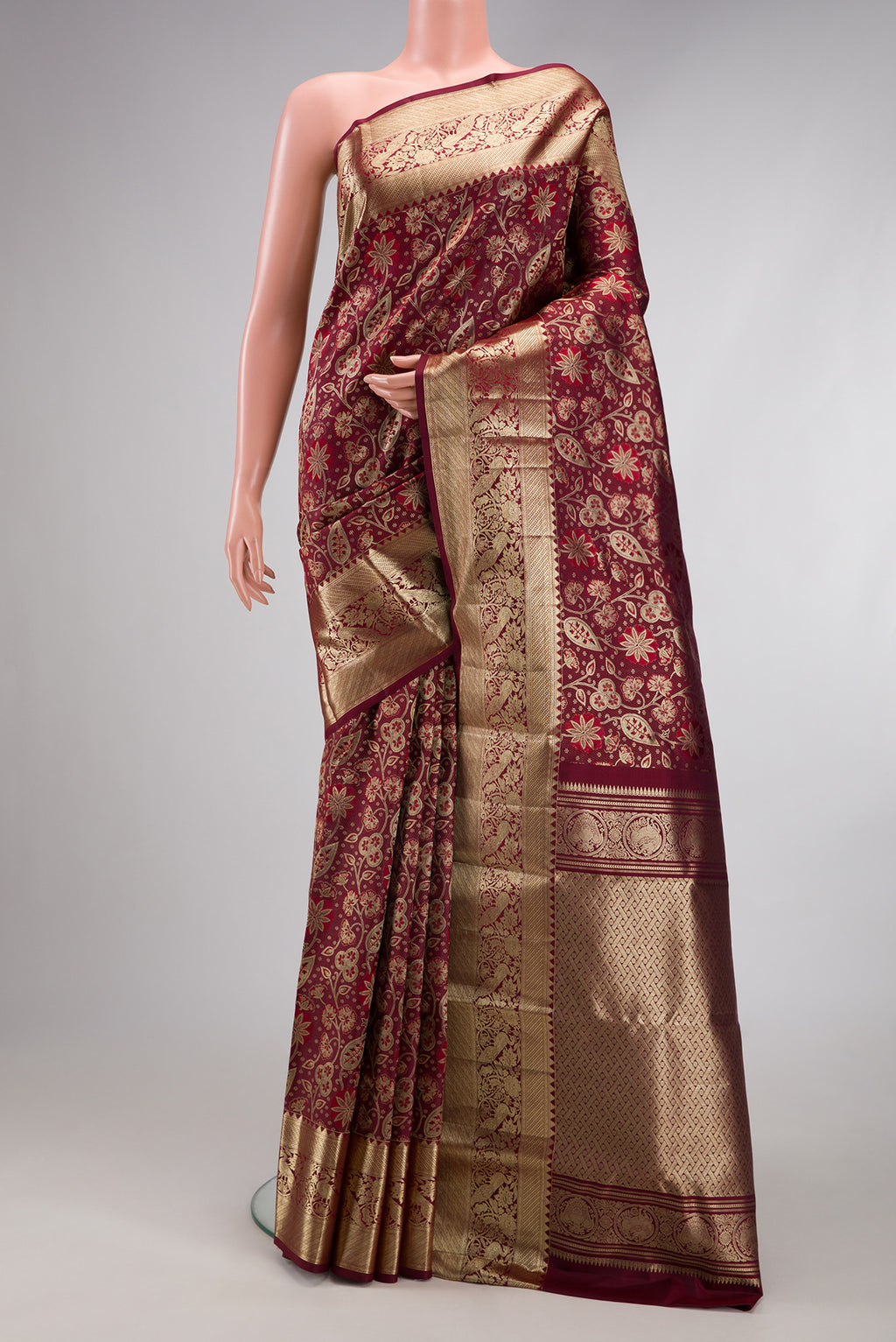 Maroon Kanchipuram Silk Saree with Zari Brocade on the body and Fancy Border.  displayed on a mannequin