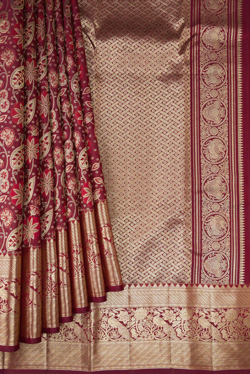 Pleats and pallu of Maroon Kanchipuram Silk Saree with Zari Brocade on the body and Fancy Border. 