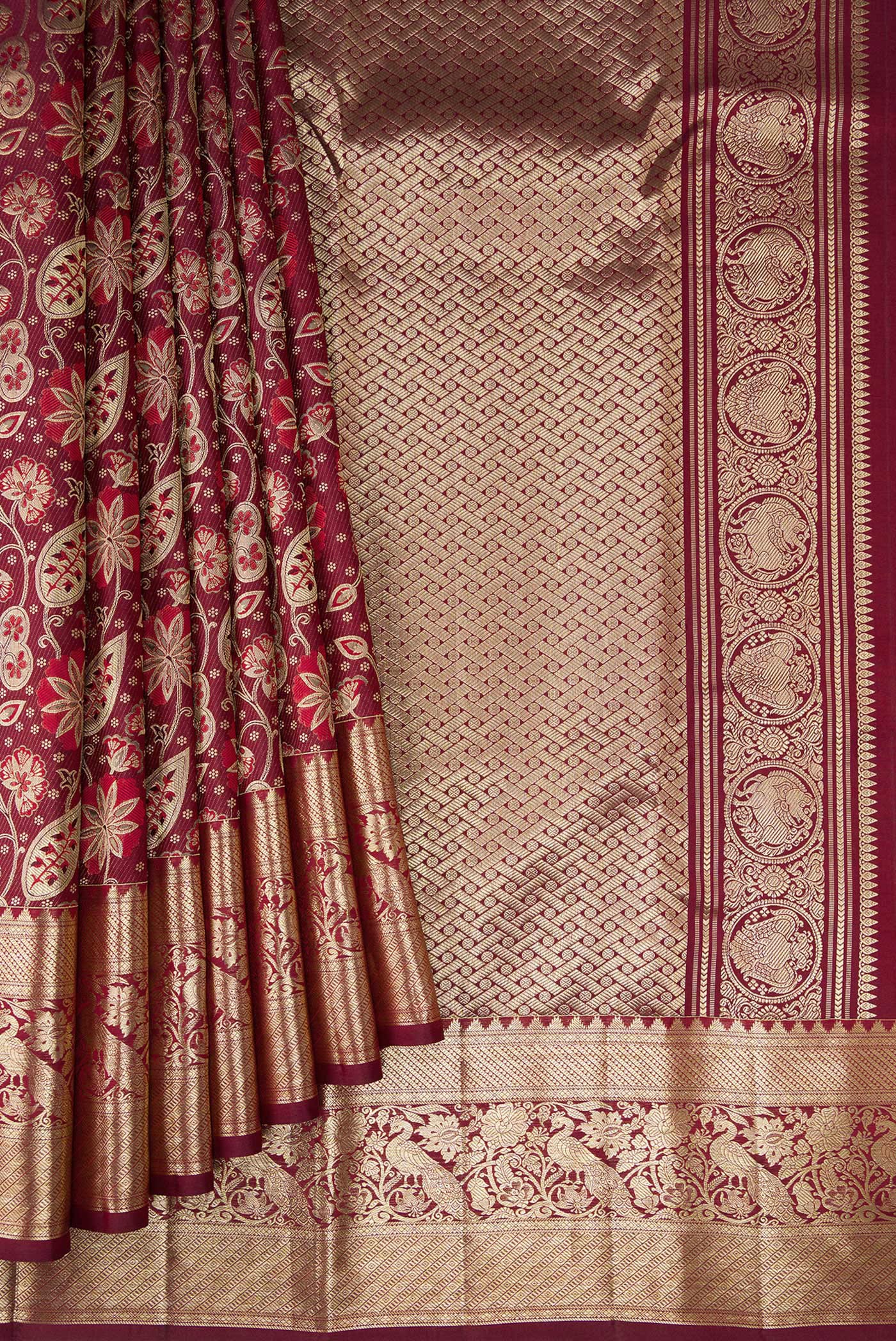 Pleats and pallu of Maroon Kanchipuram Silk Saree with Zari Brocade on the body and Fancy Border. 
