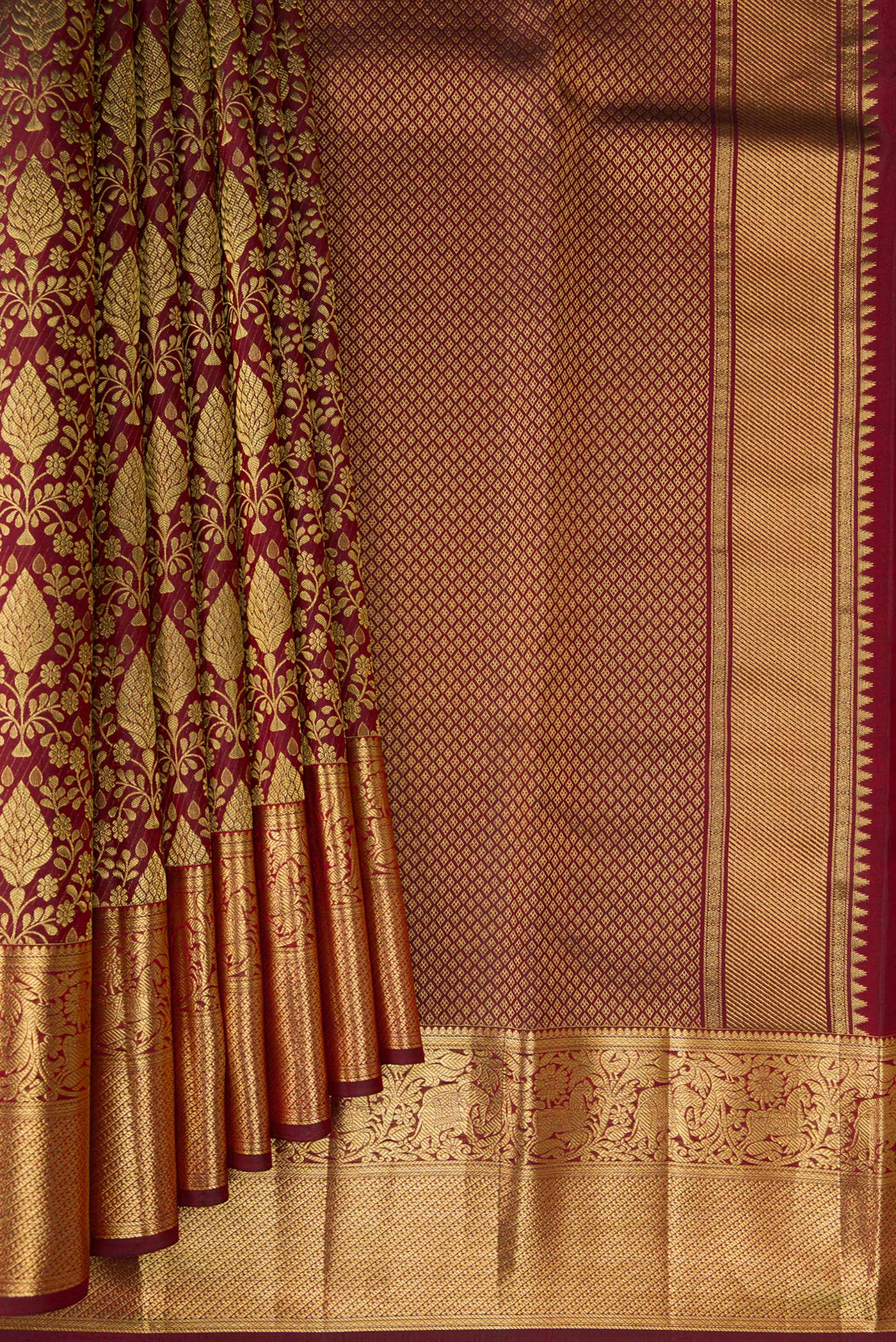 Pleats and pallu of Maroon Kanchipuram Silk Saree with Zari Brocade on the body and Zari Border. 