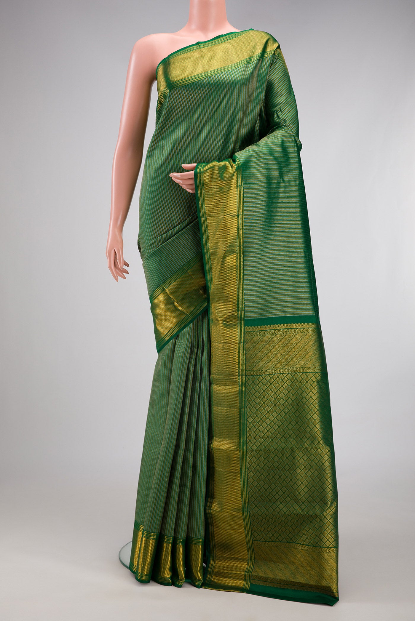Bottle Green Kanchipuram Silk Saree with Zari Brocade on the body and Zari Border.  displayed on a mannequin