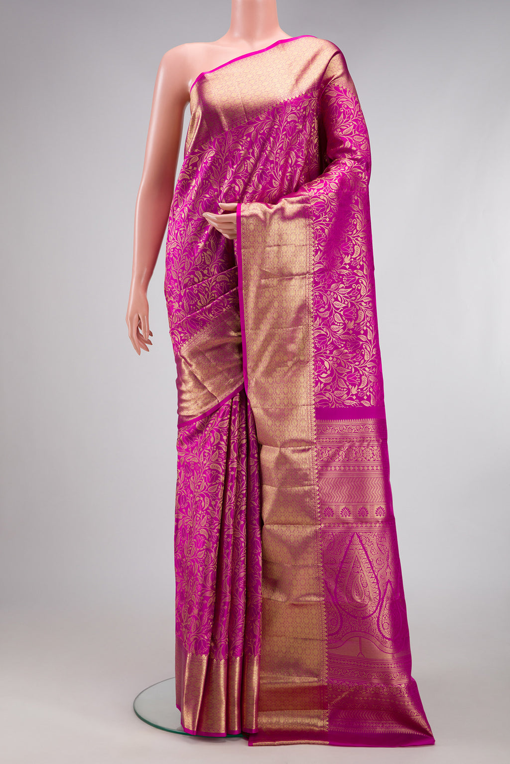 Magenta Kanchipuram Silk Saree with Zari Brocade on the body and Zari Border.  displayed on a mannequin