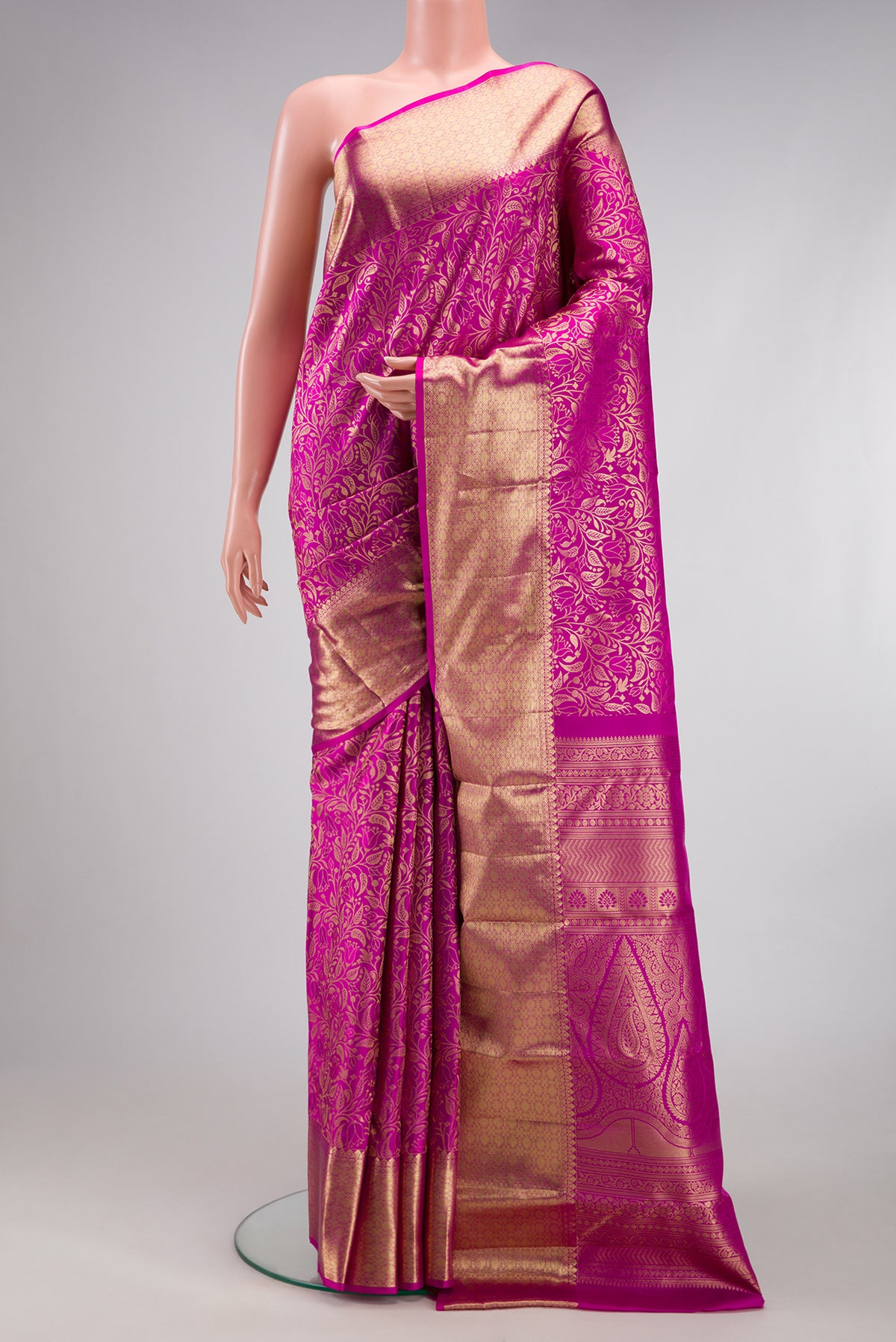 Magenta Kanchipuram Silk Saree with Zari Brocade on the body and Zari Border.  displayed on a mannequin