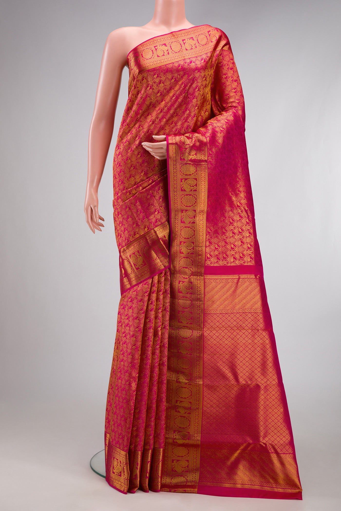 Dark Pink Kanchipuram Silk Saree with Zari Brocade on the body and Zari Border.  displayed on a mannequin