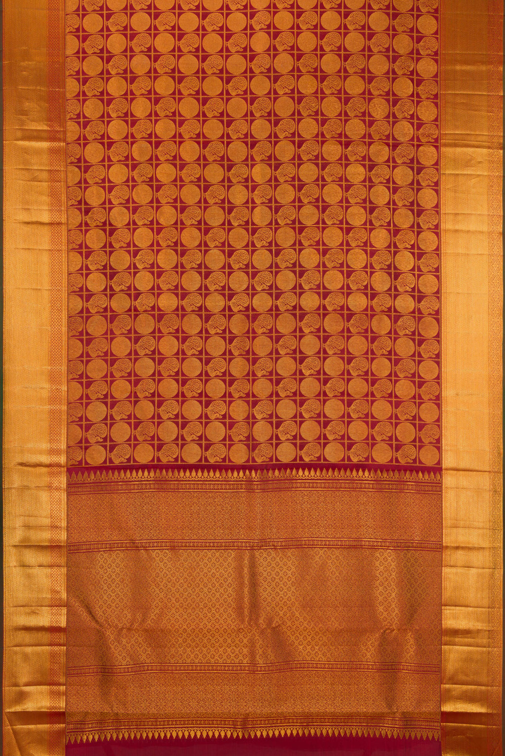 Flat view of Maroon Kanchipuram Silk Saree with Zari Brocade on the body and Zari Border. 