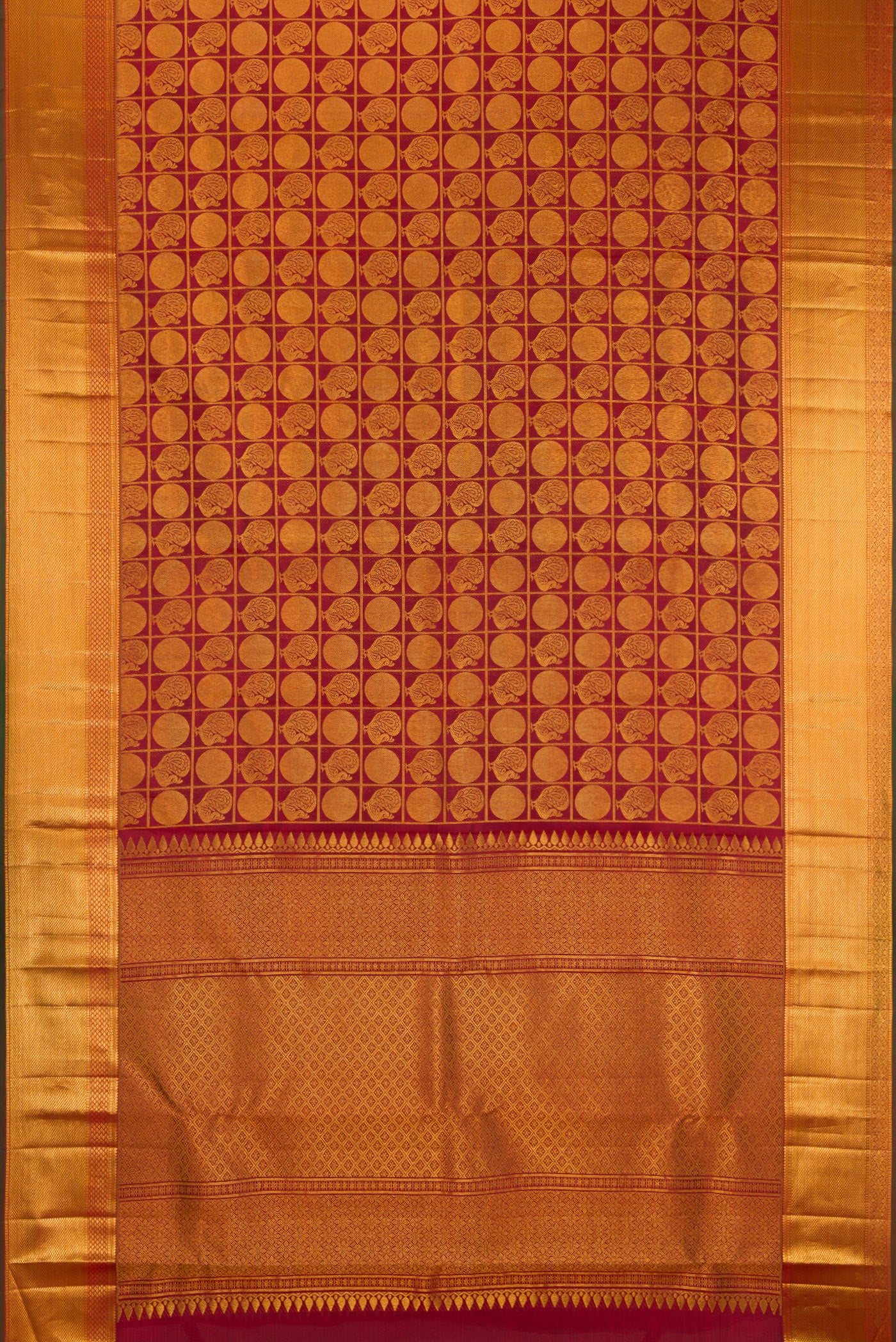 Flat view of Maroon Kanchipuram Silk Saree with Zari Brocade on the body and Zari Border. 